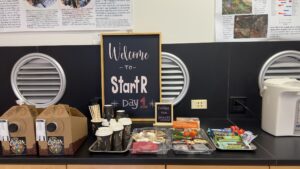 Photo of a breakfast bar with a chalkboard that reads "Welcome to StartR"